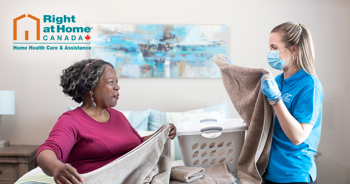 A Caregiver and a client doing chores around the home. 