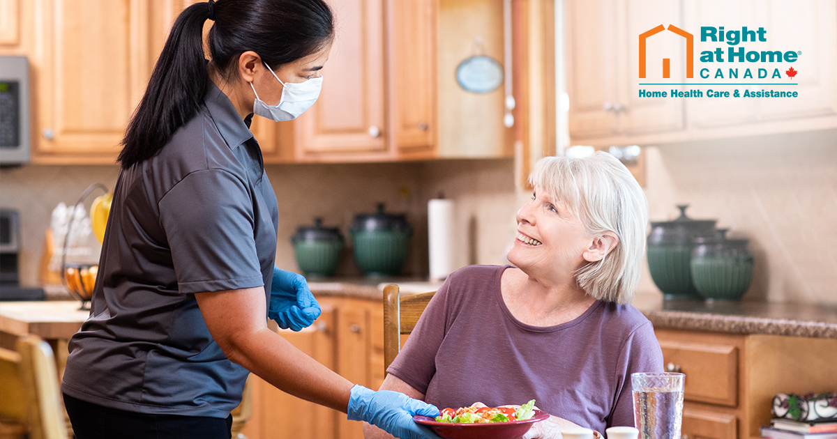 caregiver serving senior dinner