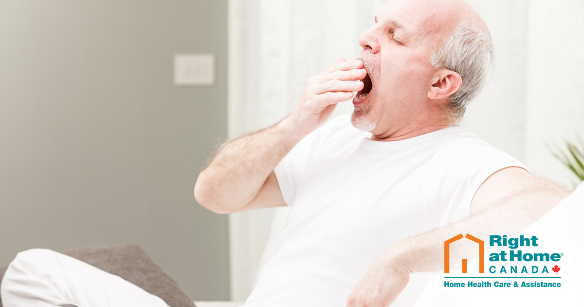 Senior in hospital bed yawning