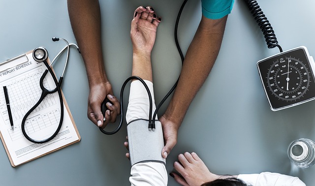 Aerial shot of person's arm receiving blood pressure test. In home care can help manage high blood pressure.