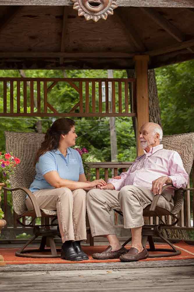 caregiver with senior outside under gazebo