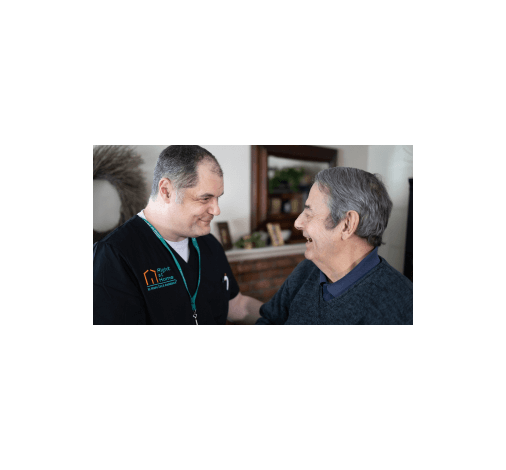 A caregiver is flipping through a book with his client
