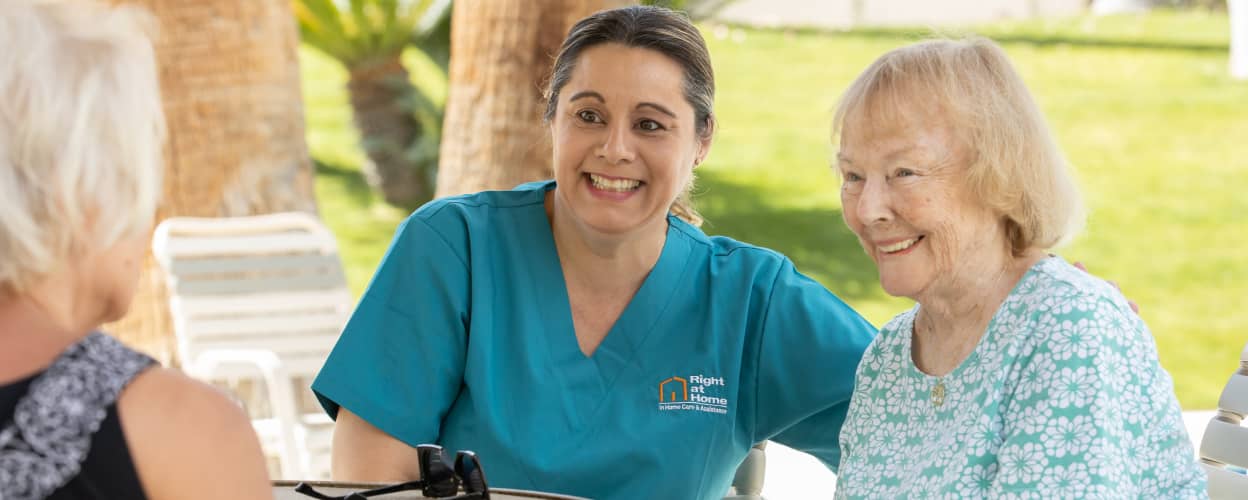 Female caregiver on the phone, smiling.