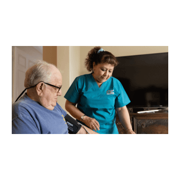 A female nurse assists with a blood pressure device attached to a male patient's arm.